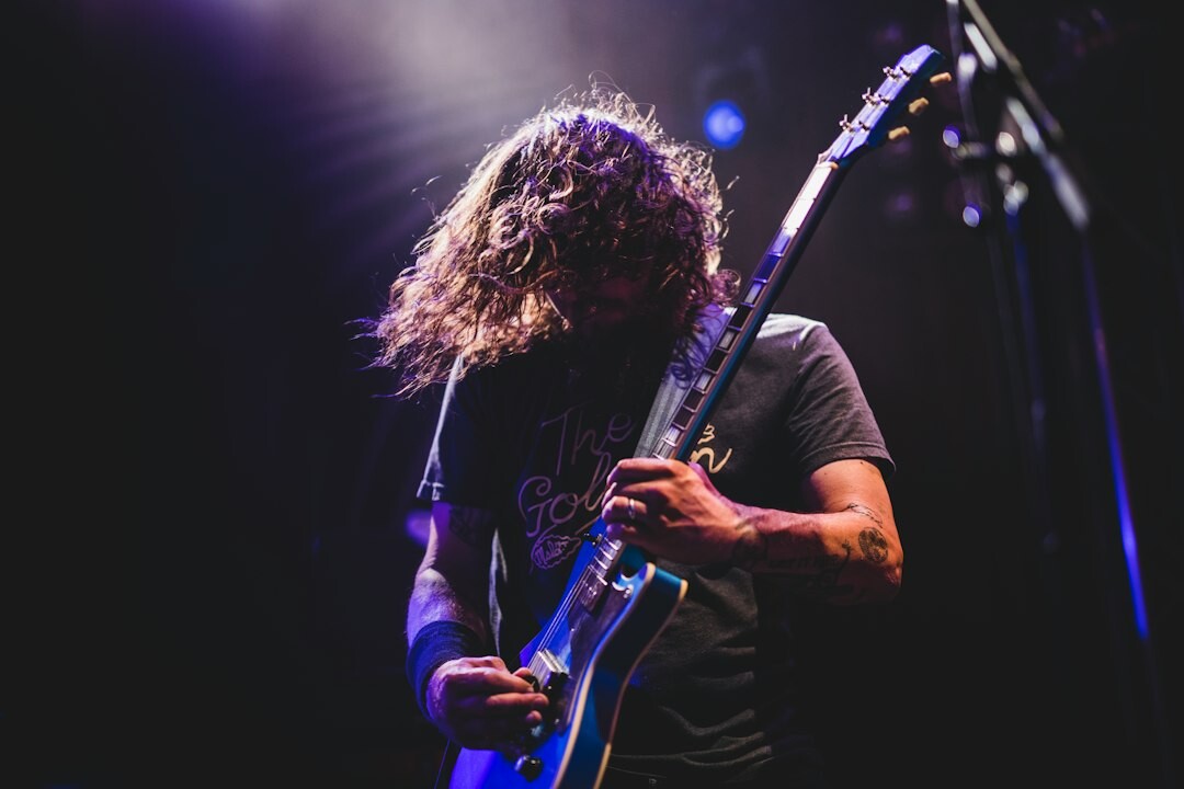 Musician playing electric guitar at a live concert